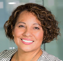 Portrait of Claire Ashford, head of compliance, against a background of financial regulation